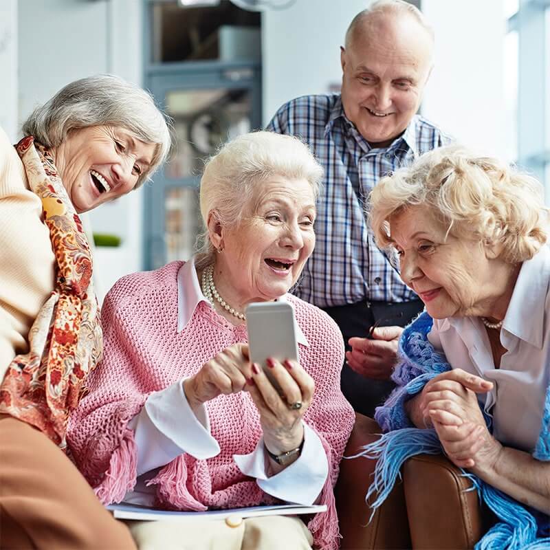 Seniors sharing mobile phone