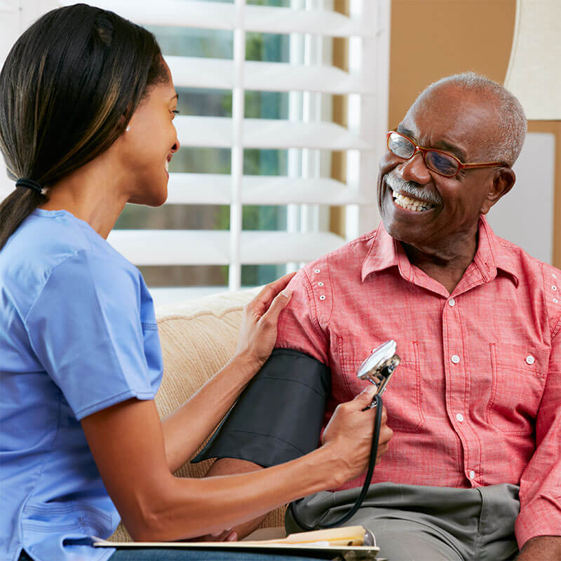 Senior man getting his blood pressure checked by a nurse