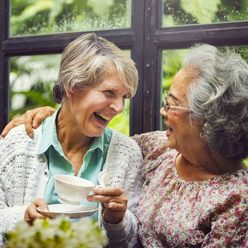 Senior women sharing some laughs over a cup of coffee