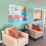 hallway seating with two leather armchairs and pillows