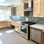 View of kitchen with gas stove, oven, and dishwasher