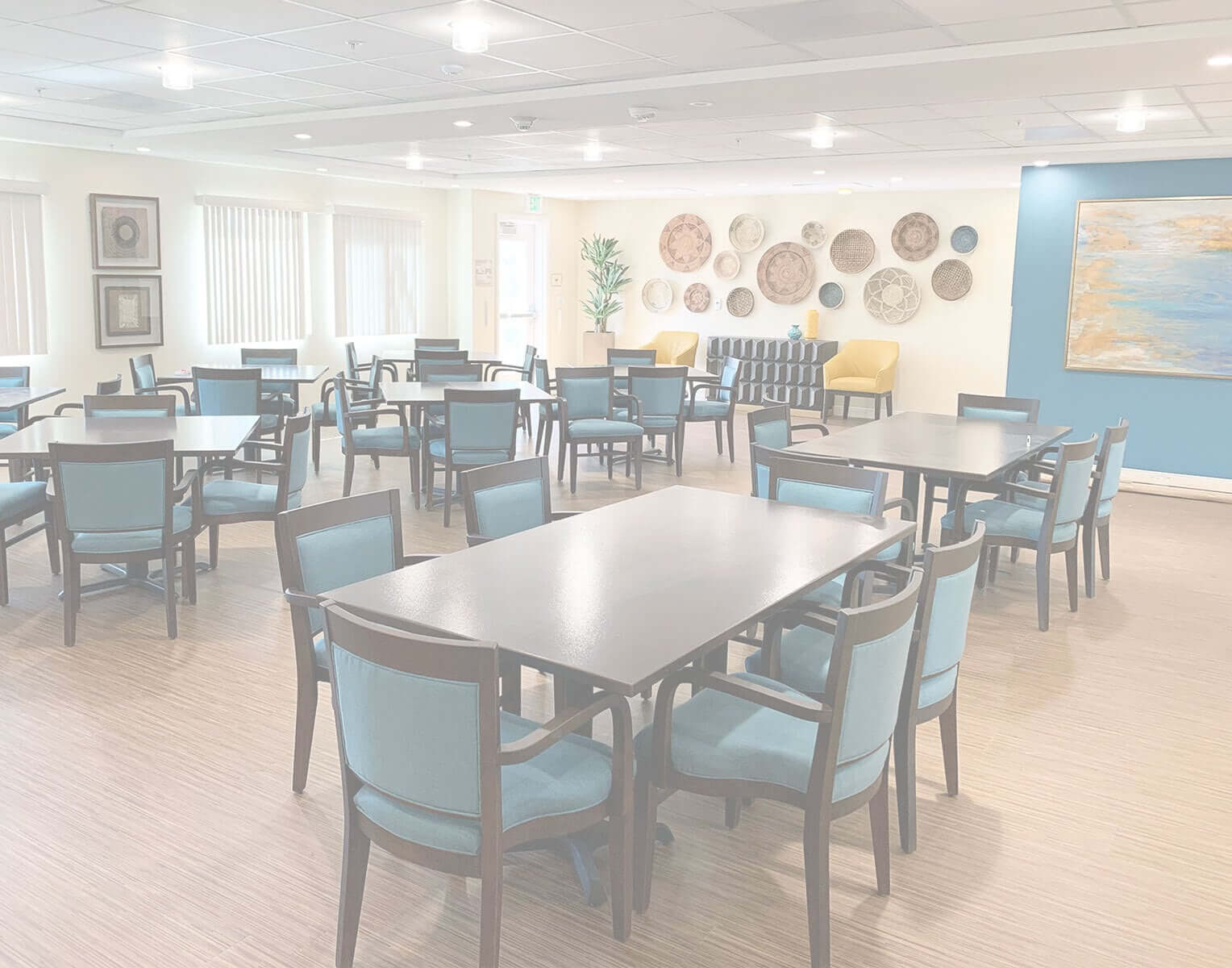 Dining room view of wood tables and comfortable padded seating