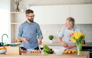 Senior man and son preparing a meal in kitchen