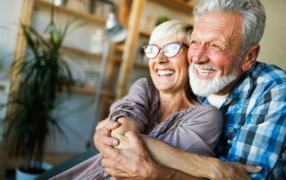 Happy senior couple cuddling and smiling
