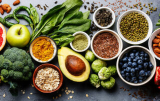 Healthy foods, fruits, vegetables and grains laid out on table
