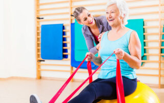 Senior woman with physical therapist in assisted living community